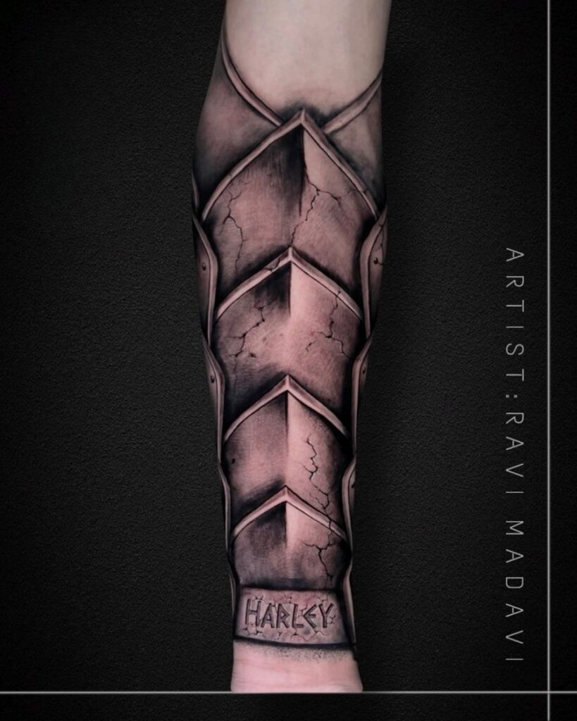 Armour forearm tattoo with lettering