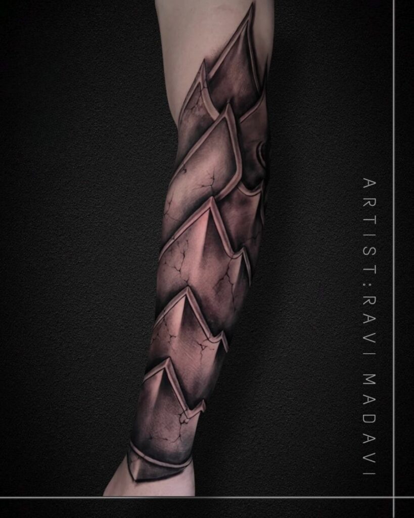Armour-plate sleeve tattoo in black and grey