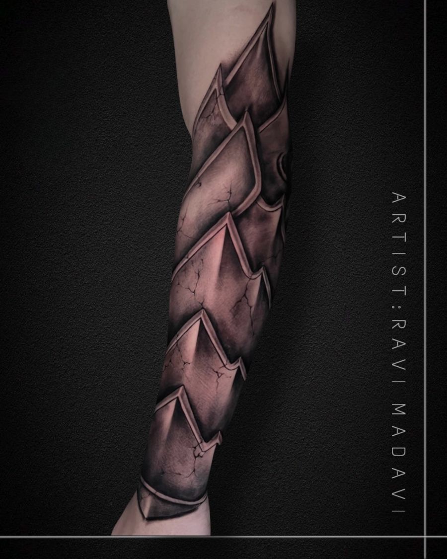 Armour-plate sleeve tattoo in black and grey