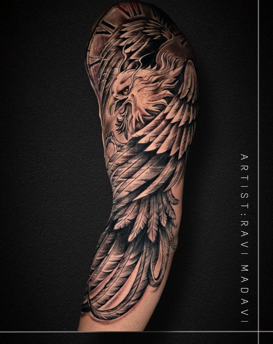 Black and grey feathered wing half-sleeve tattoo